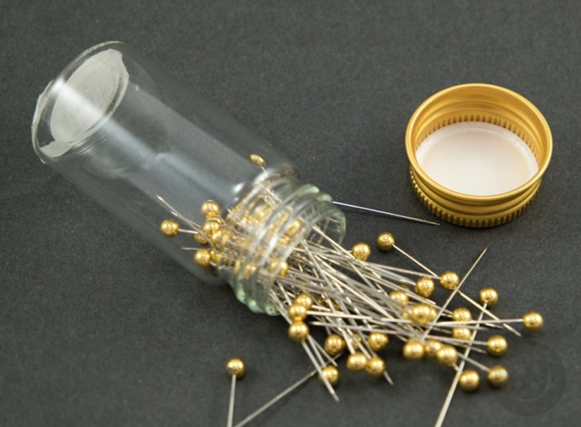 Decorative pins in a glass bottle - gold head
