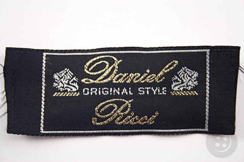 Sew-on patch Daniel Ricci - black, silver, gold - dimensions 7 cm x 3 cm