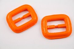 Plastic clothing buckle - orange - pulling hole width 2,5 cm - dimensions 3,8 cm x 3,2 cm