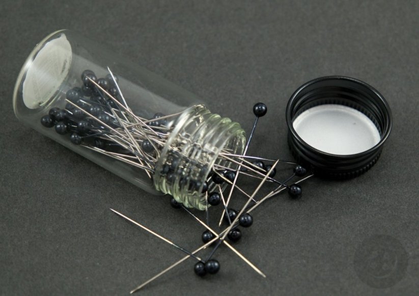 Decorative pins in a glass bottle - black head