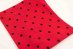black polka dots on a red background