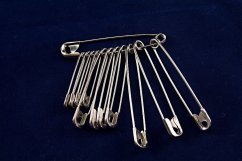A mixture of large silver safety pins