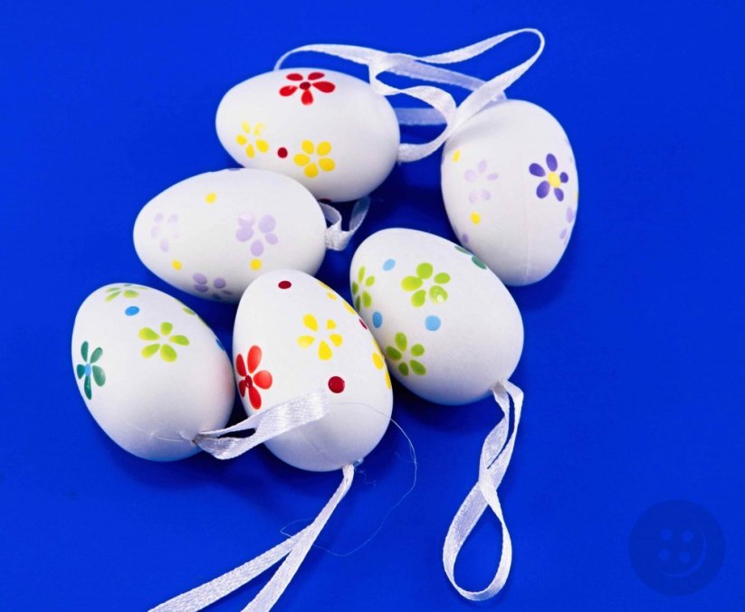 Easter eggs with flowers on a ribbon - green, red, yellow, purple