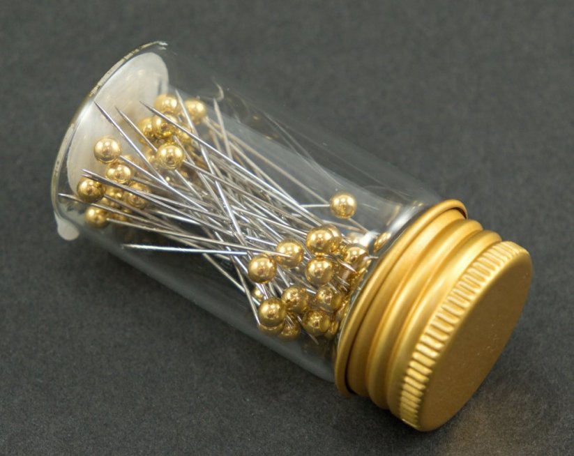Decorative pins in a glass bottle - gold head