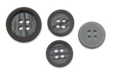 Brown suit button with matte surface and mother-of-pearl center