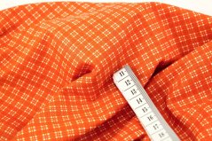 Baumwollstoff - cremefarbene Würfel auf orangefarbenem Hintergrund - Breite 140 cm