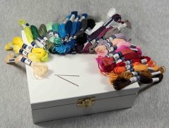 A mixture of Moulline embriodery yarns in a box made of pine wood