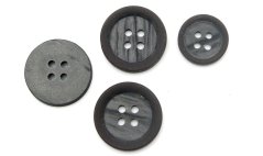 Brown suit button with matte surface and mother-of-pearl center
